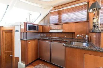 Slide: The Image of Luxurious kitchen interior of 2005 Sea Ray 500 Sedan Bridge yacht with wood cabinetry. - 46