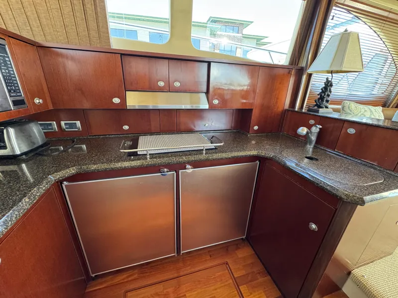 Slide: The Image of Luxurious kitchen in 2005 Sea Ray 500 Sedan Bridge yacht with modern appliances. - 47