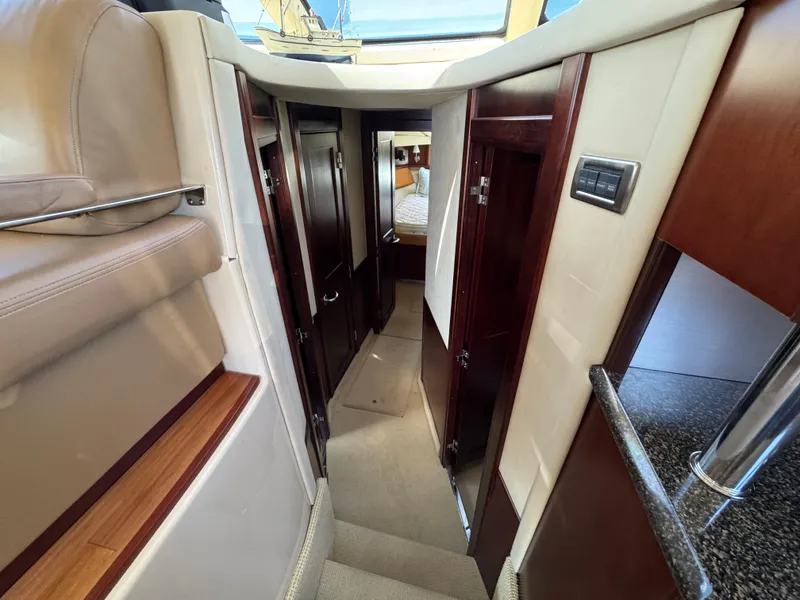 Slide: The Image of Interior hallway of 2005 Sea Ray 500 Sedan Bridge yacht, featuring wood accents and modern design. - 49