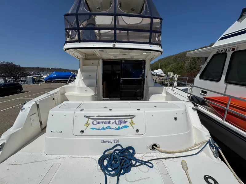 Slide: The Image of 2005 Sea Ray 500 Sedan Bridge yacht docked, featuring spacious deck and upper helm. - 5