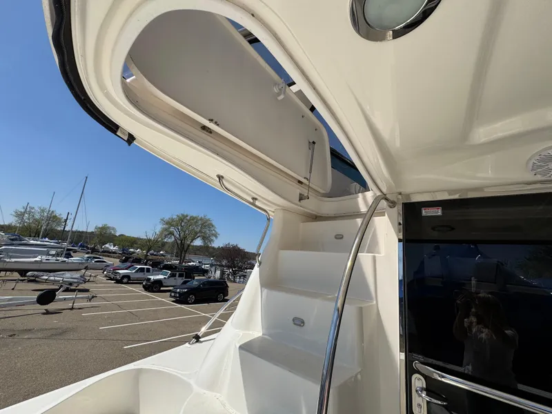Slide: The Image of 2005 Sea Ray 500 Sedan Bridge yacht stairs with open hatch, docked in a marina. - 7