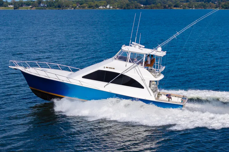 Slide: The Image of 2005 Ocean Yachts Super Sport cruising on blue ocean waters. - 12