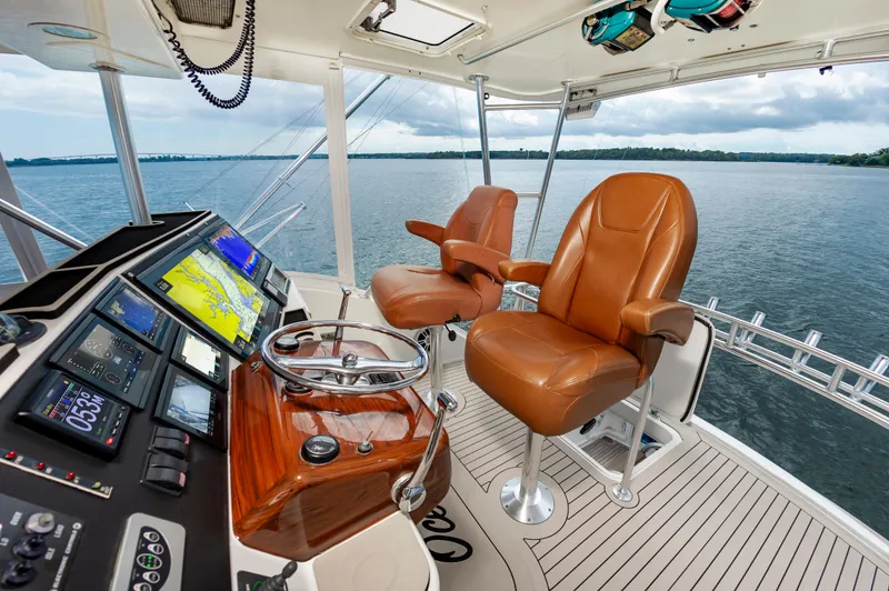 Slide: The Image of 2005 Ocean Yachts Super Sport helm with leather seats and navigation displays. - 15