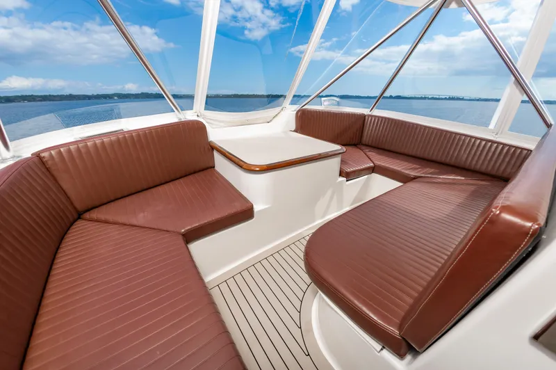 Slide: The Image of Luxurious 2005 Ocean Yachts Super Sport interior with brown leather seating and ocean view. - 16