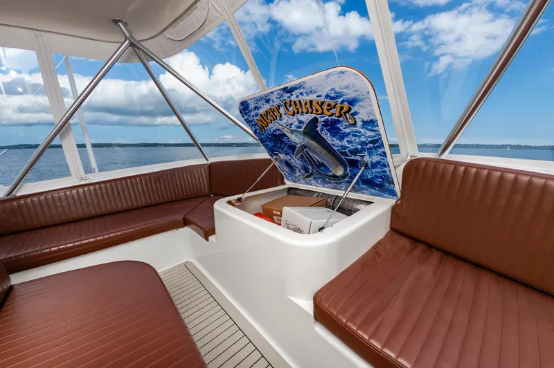 Slide: The Image of Interior of 2005 Ocean Yachts Super Sport with brown seating and ocean view. - 18