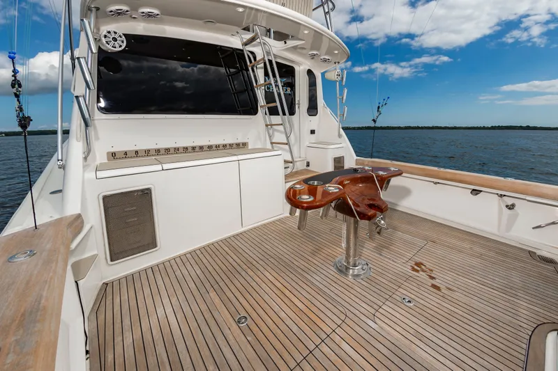 Slide: The Image of 2005 Ocean Yachts Super Sport boat deck with fishing chair, ocean view, and clear sky. - 22