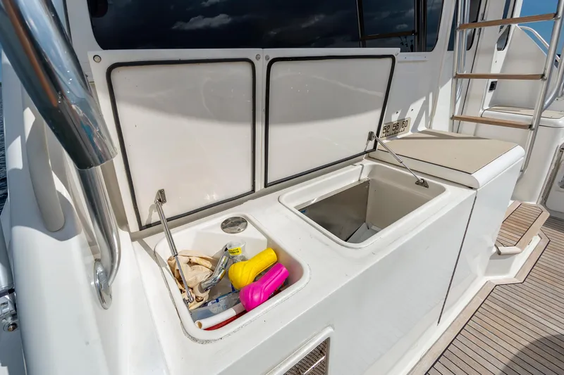 Slide: The Image of 2005 Ocean Yachts Super Sport deck with storage compartments and seating. - 23