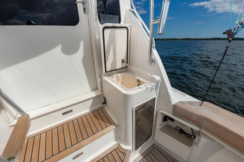 Slide: The Image of 2005 Ocean Yachts Super Sport deck with wooden steps and ocean view. - 24