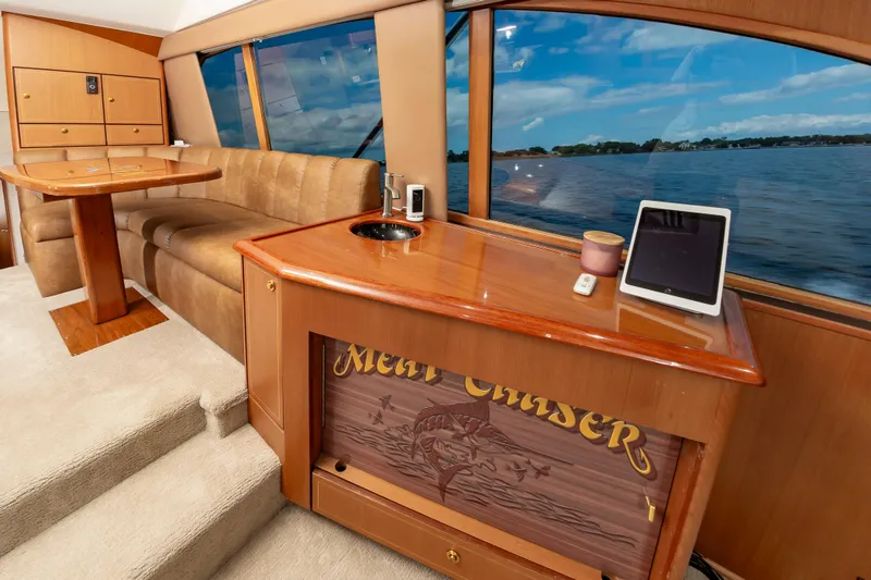Slide: The Image of Interior of 2005 Ocean Yachts Super Sport with luxurious seating and scenic window view. - 27
