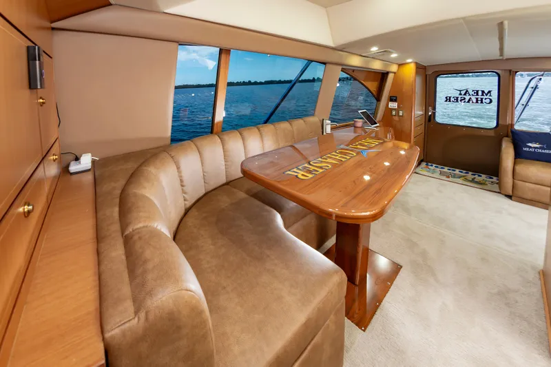 Slide: The Image of Luxurious interior of 2005 Ocean Yachts Super Sport with plush seating and wooden table. - 30