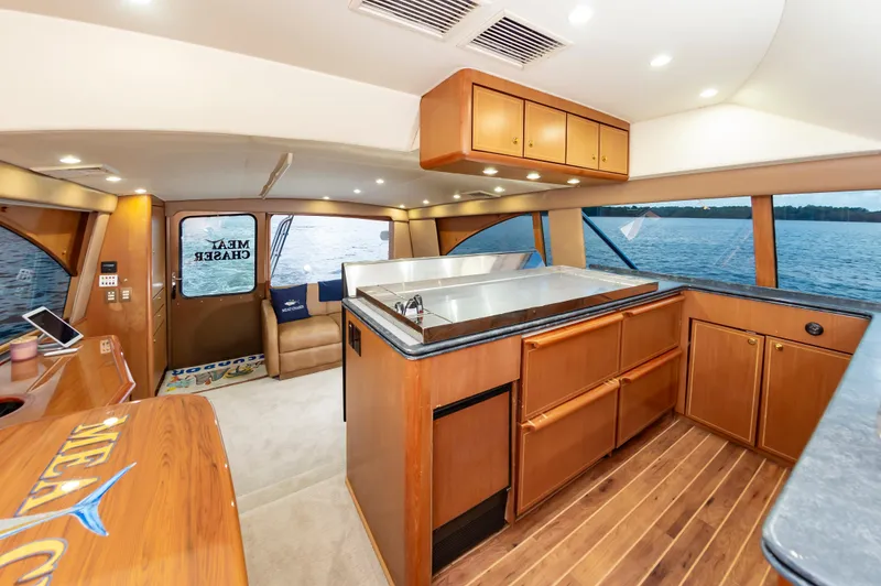 Slide: The Image of Luxurious 2005 Ocean Yachts Super Sport interior with wood cabinetry and scenic ocean view. - 32