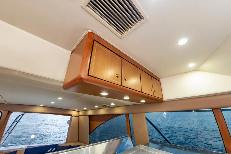 Slide: The Image of Interior of 2005 Ocean Yachts Super Sport, featuring wooden cabinets and ocean view. - 35