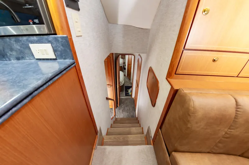 Slide: The Image of Interior view of 2005 Ocean Yachts Super Sport, featuring wooden cabinetry and stairs. - 37