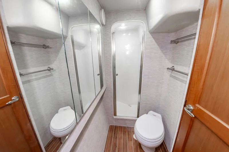 Slide: The Image of 2005 Ocean Yachts Super Sport bathroom with shower, toilet, and mirrored cabinets. - 42
