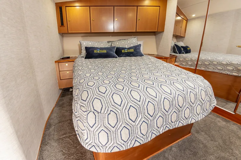 Slide: The Image of Luxurious bedroom interior of 2005 Ocean Yachts Super Sport with patterned bedding. - 43