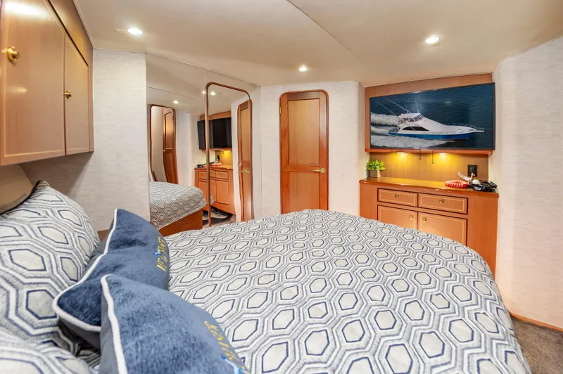 Slide: The Image of Luxurious 2005 Ocean Yachts Super Sport bedroom with elegant decor and modern amenities. - 44