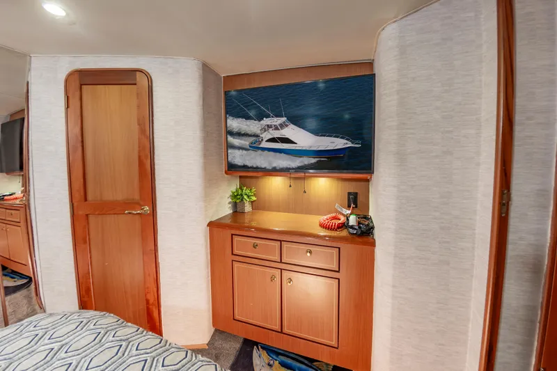 Slide: The Image of Interior of 2005 Ocean Yachts Super Sport with wooden cabinetry and yacht artwork. - 45
