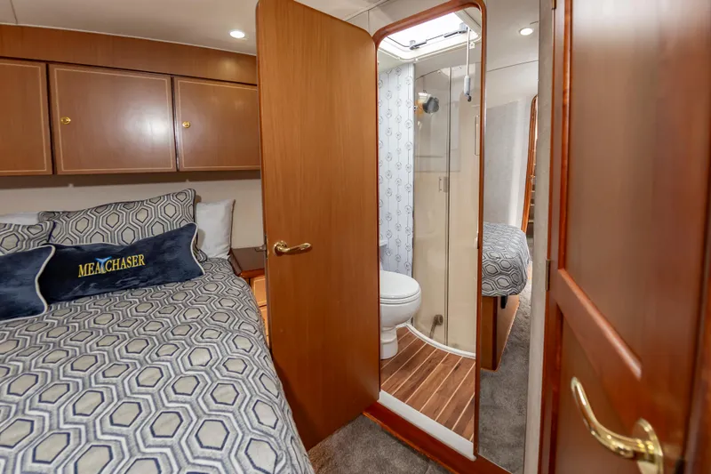 Slide: The Image of Luxurious 2005 Ocean Yachts Super Sport cabin with ensuite bathroom and elegant bedding. - 46