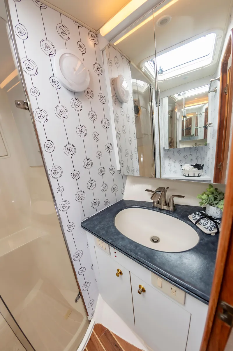 Slide: The Image of Luxurious 2005 Ocean Yachts Super Sport bathroom with modern sink and stylish wallpaper. - 47