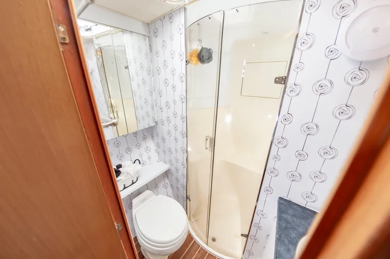 Slide: The Image of Bathroom interior of 2005 Ocean Yachts Super Sport with shower and patterned wallpaper. - 48