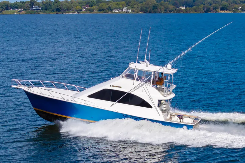 Slide: The Image of 2005 Ocean Yachts Super Sport cruising on blue water. - 8