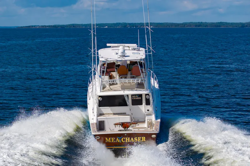 Slide: The Image of 2005 Ocean Yachts Super Sport cruising on open water, rear view. - 9