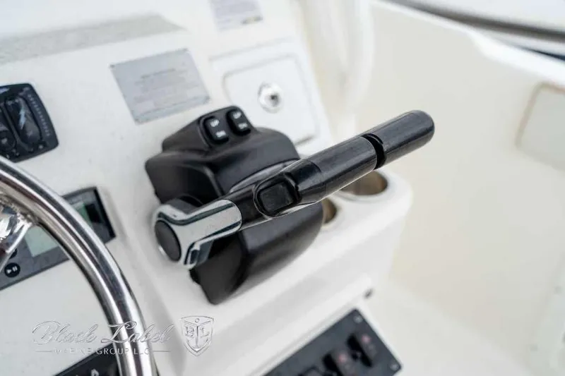 Slide: The Image of Close-up of 2017 Century 2600 boat throttle control and steering wheel. - 14
