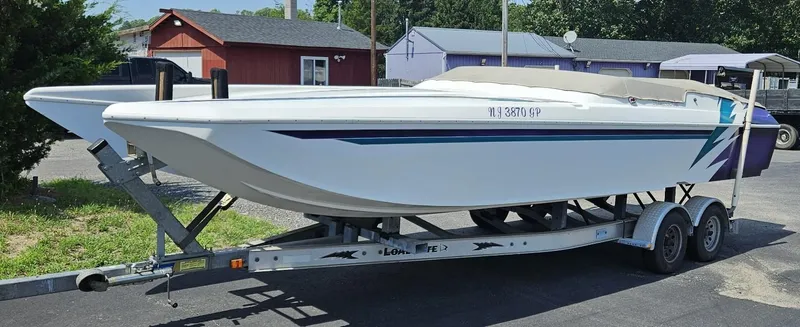 Slide: The Image of 2000 Eliminator 25 Daytona boat on trailer, parked outdoors. - 15