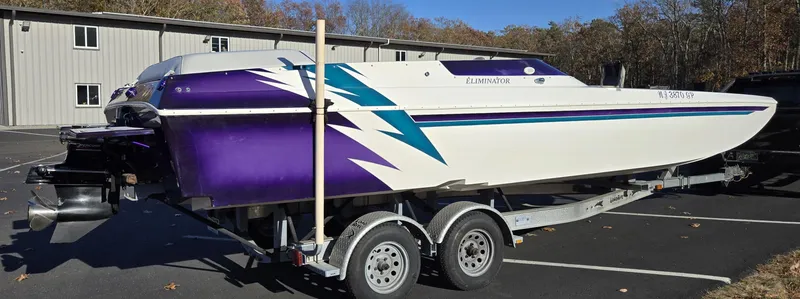 Slide: The Image of 2000 Eliminator 25 Daytona speedboat on trailer, featuring purple and teal accents. - 20