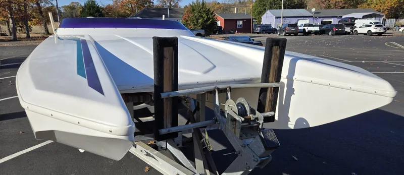 Slide: The Image of 2000 Eliminator 25 Daytona boat on trailer in parking lot, viewed from the front. - 21