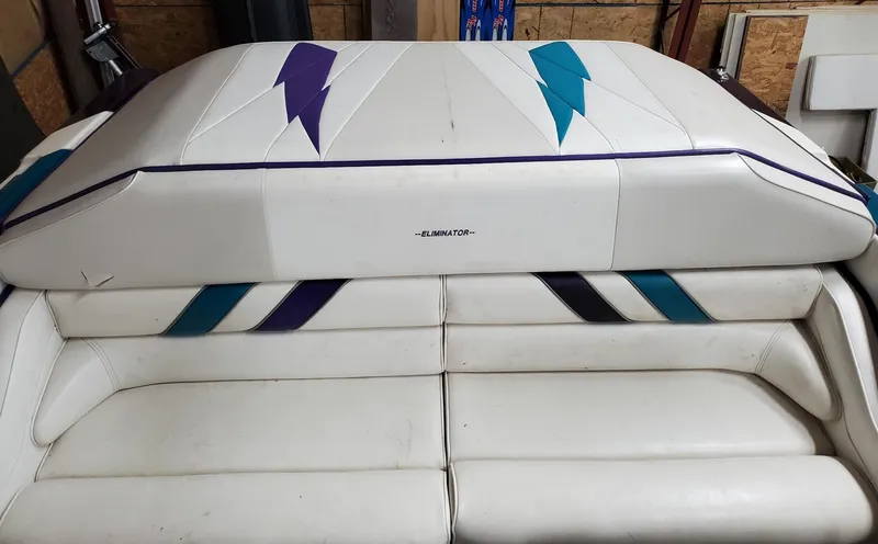 Slide: The Image of 2000 Eliminator 25 Daytona boat interior with white and colored upholstery design. - 25