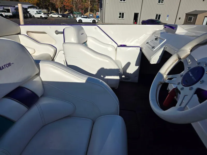 Slide: The Image of Interior of a 2000 Eliminator 25 Daytona boat with white and purple seating. - 29