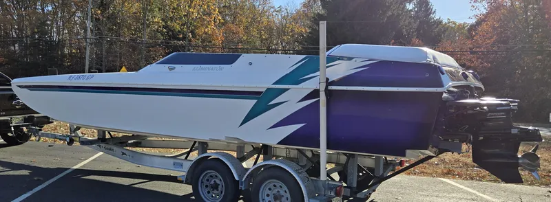 Slide: The Image of 2000 Eliminator 25 Daytona speedboat on trailer, featuring sleek design and vibrant graphics. - 3