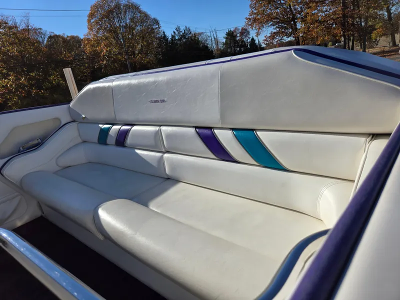 Slide: The Image of 2000 Eliminator 25 Daytona boat interior with white leather seating and colorful accents. - 30