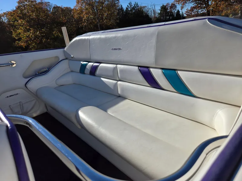 Slide: The Image of 2000 Eliminator 25 Daytona boat interior with white leather seats and colorful accents. - 5