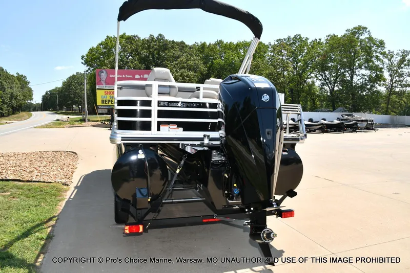 Slide: The Image of 2025 Ranger 223FC boat with 200HP Mercury 4 Stroke engine, parked outdoors. - 14