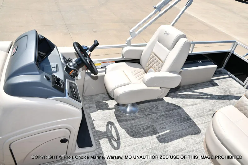 Slide: The Image of 2025 Ranger 223FC boat interior with steering console and plush seating. - 29