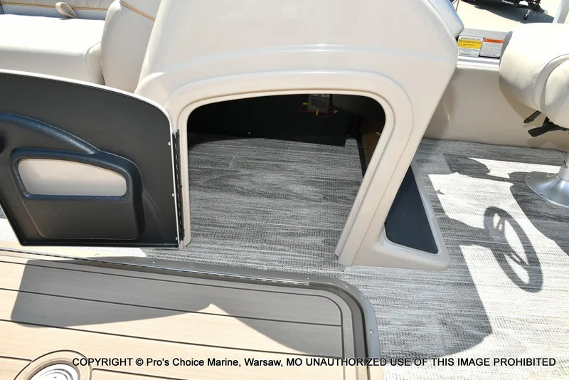 Slide: The Image of Open storage compartment on 2025 Ranger 223FC boat with carpeted flooring. - 34