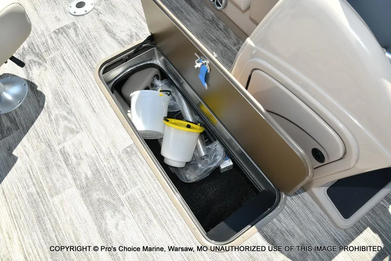 Slide: The Image of Open storage compartment on 2025 Ranger 223FC boat with buckets and accessories. - 36