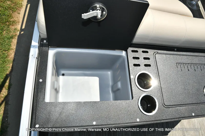 Slide: The Image of 2025 Ranger 223FC boat interior with storage compartment and cup holders. - 47