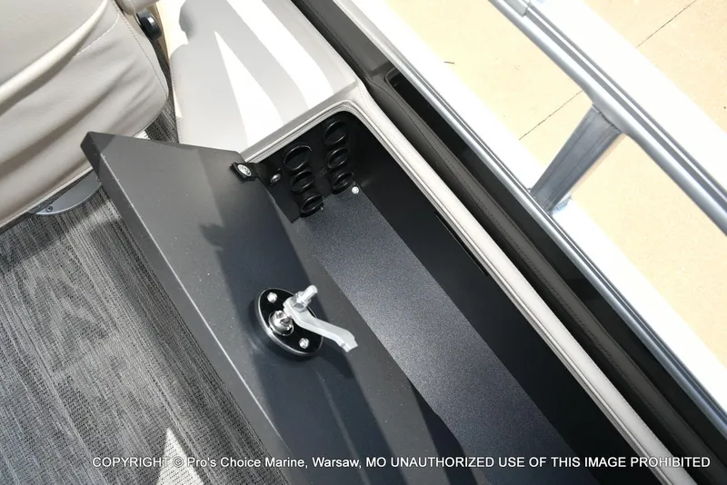 Slide: The Image of Storage compartment in 2025 Ranger 223FC boat with secure latch and cup holders. - 49