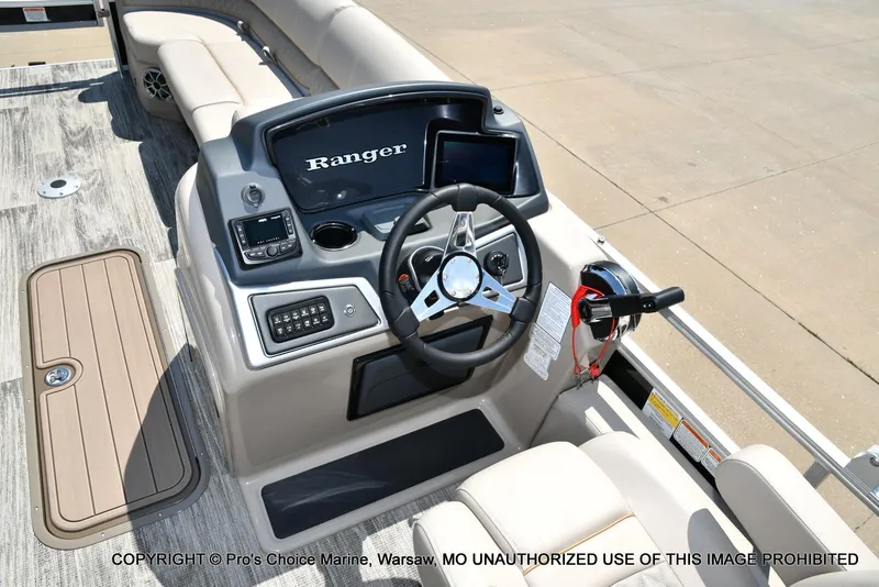 Slide: The Image of 2025 Ranger 223FC boat dashboard with steering wheel and controls. - 8