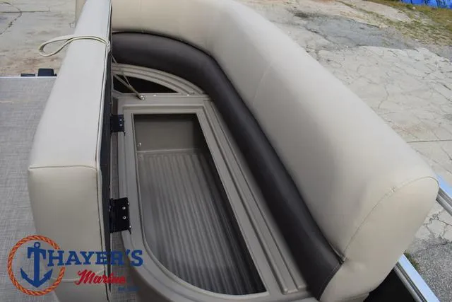 Slide: The Image of 2025 Sun Tracker PARTY BARGE® 16 DLX seating area with storage compartment. - 14