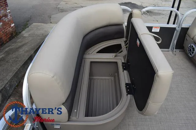 Slide: The Image of 2025 Sun Tracker PARTY BARGE® 16 DLX pontoon boat with open storage compartment. - 16