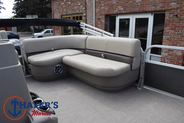 Slide: The Image of 2025 Sun Tracker PARTY BARGE® 16 DLX pontoon boat with beige seating and speaker system. - 17