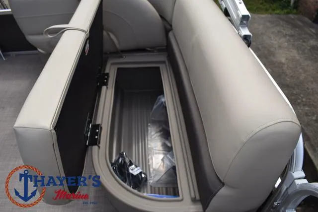 Slide: The Image of 2025 Sun Tracker PARTY BARGE® 16 DLX boat seat with storage compartment open. - 18