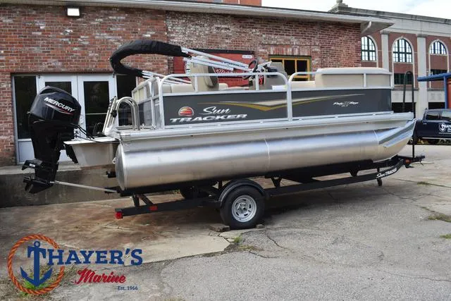 Slide: The Image of 2025 Sun Tracker PARTY BARGE® 16 DLX pontoon boat on trailer at Thayer's Marine. - 3
