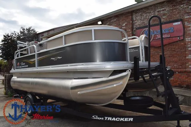 Slide: The Image of 2025 Sun Tracker PARTY BARGE® 16 DLX pontoon boat on trailer at Thayer's Marine. - 32