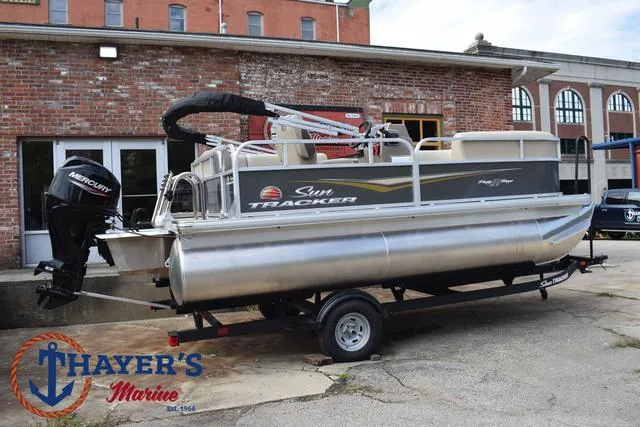 Slide: The Image of 2025 Sun Tracker PARTY BARGE® 16 DLX pontoon boat on trailer at Thayer's Marine. - 34