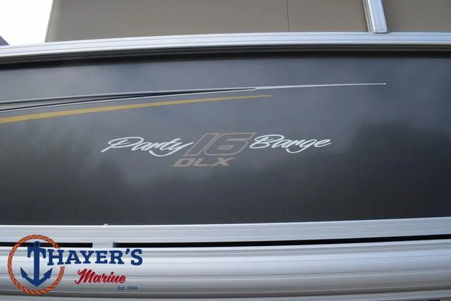 Slide: The Image of 2025 Sun Tracker PARTY BARGE® 16 DLX boat side view with Thayer's Marine logo. - 5